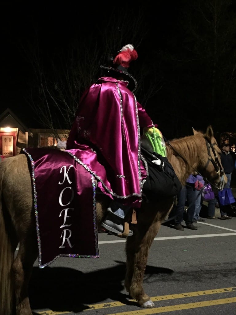 A KOER member sits atop a Mardi Gras parade horse.
